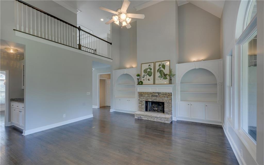 2092 Bakers Mill Road Dacula, GA 30019 - Photo 10 of 65 a living room with wooden floor and a fireplace