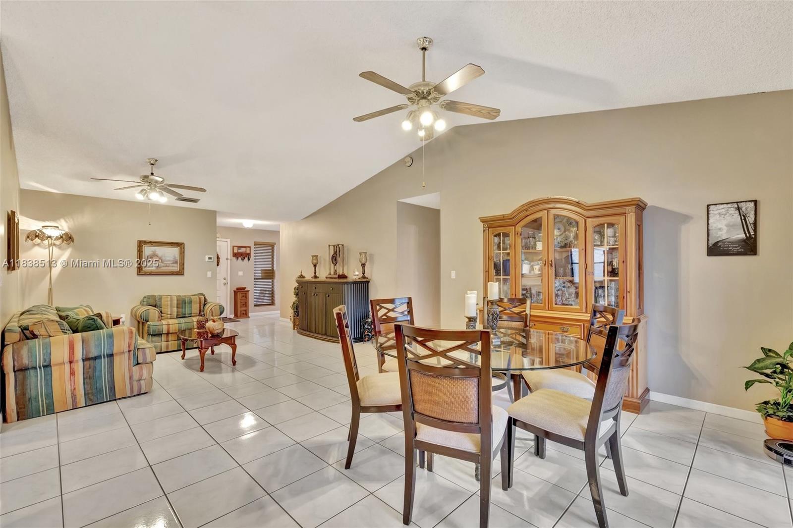 5911 Epsom Court Davie, FL 33331 - Photo 12 of 38 a dining room with furniture and chandelier fan