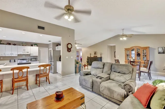 a living room with furniture and a view of kitchen