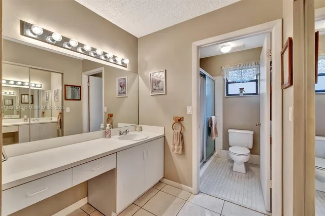 a spacious bathroom with a double vanity sink and a mirror