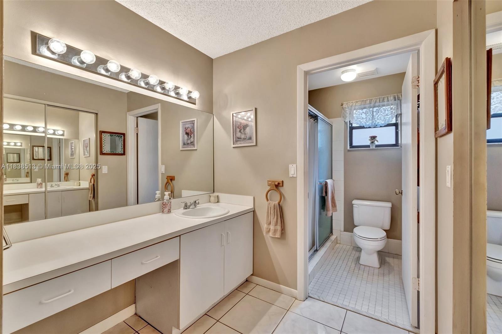 5911 Epsom Court Davie, FL 33331 - Photo 22 of 38 a spacious bathroom with a double vanity sink and a mirror