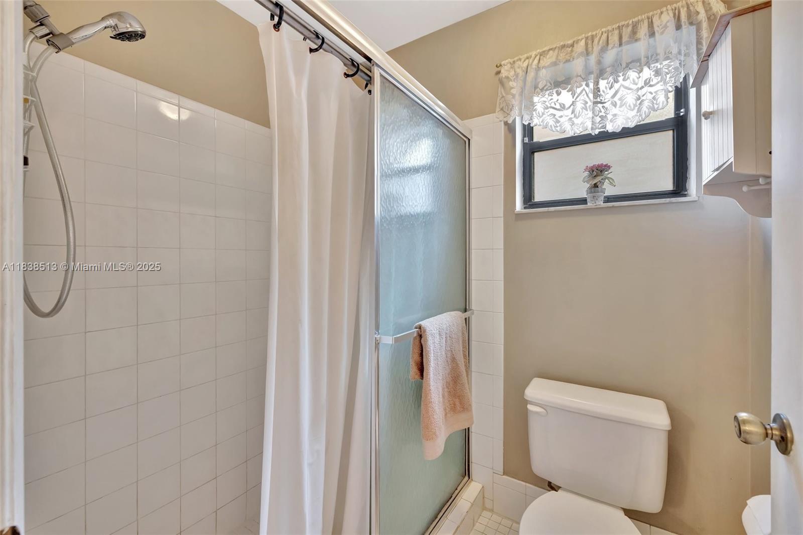 5911 Epsom Court Davie, FL 33331 - Photo 23 of 38 a bathroom with a toilet and a shower