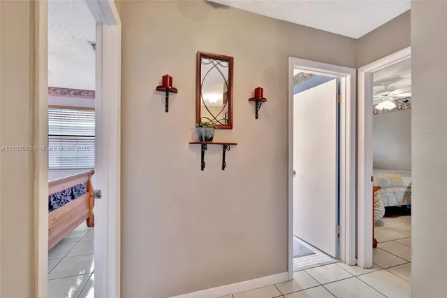 a view of a hallway with closet and a potted plant