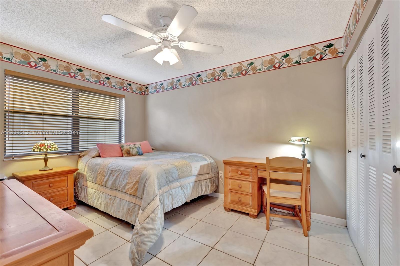 5911 Epsom Court Davie, FL 33331 - Photo 27 of 38 a bedroom with a bed and a chandelier