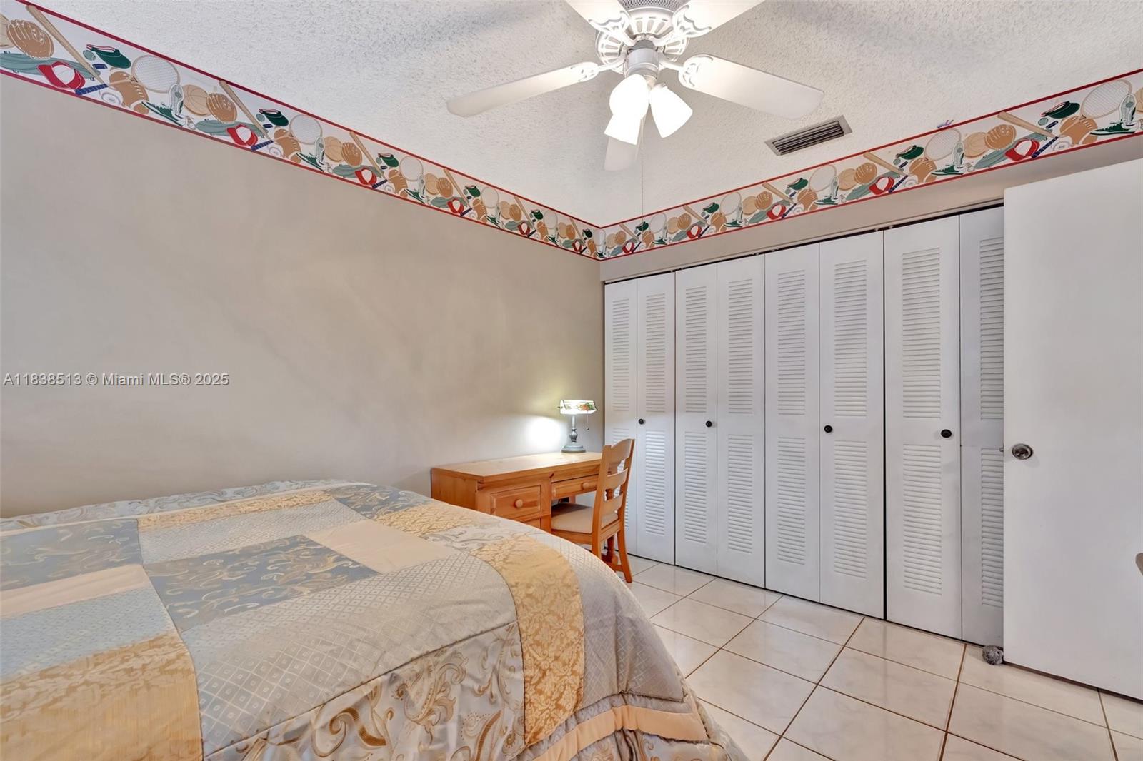 5911 Epsom Court Davie, FL 33331 - Photo 28 of 38 a bedroom with a bed and a chandelier