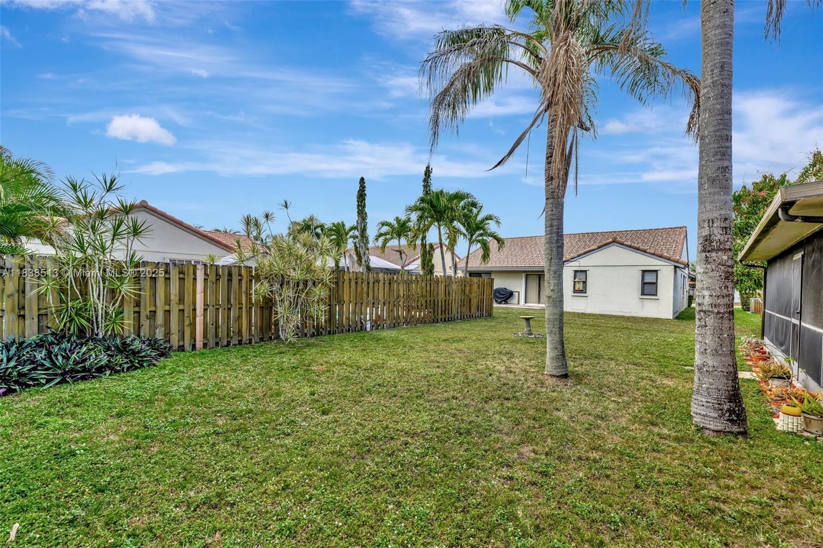5911 Epsom Court Davie, FL 33331 - Photo 37 of 38 a view of a house with a small yard and palm trees
