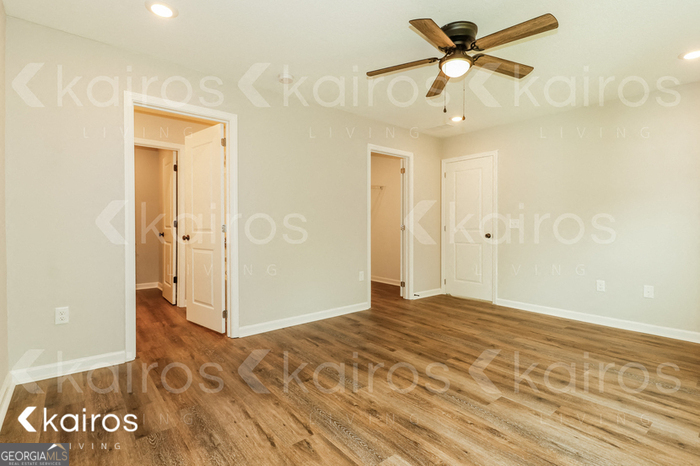 126 Cottage Grove Road Brunswick, GA 31525 - Photo 11 of 17 a view of a big room with wooden floor and a ceiling fan