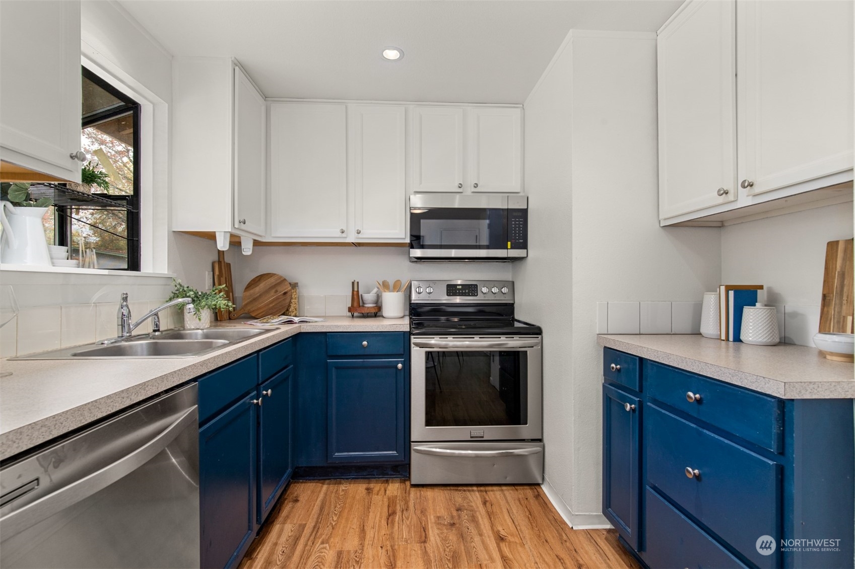 22700 1st Place West Bothell, WA 98021 - Photo 13 of 32 a kitchen with stainless steel appliances a sink dishwasher stove and oven