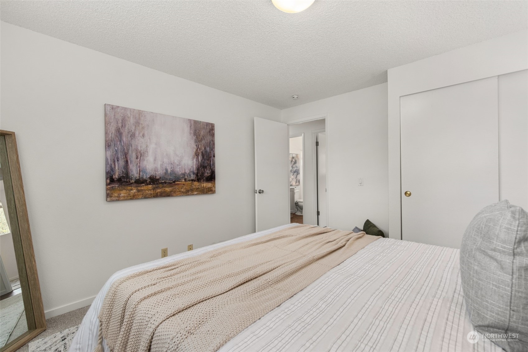 22700 1st Place West Bothell, WA 98021 - Photo 17 of 32 a bedroom with a bed and a painting on the wall