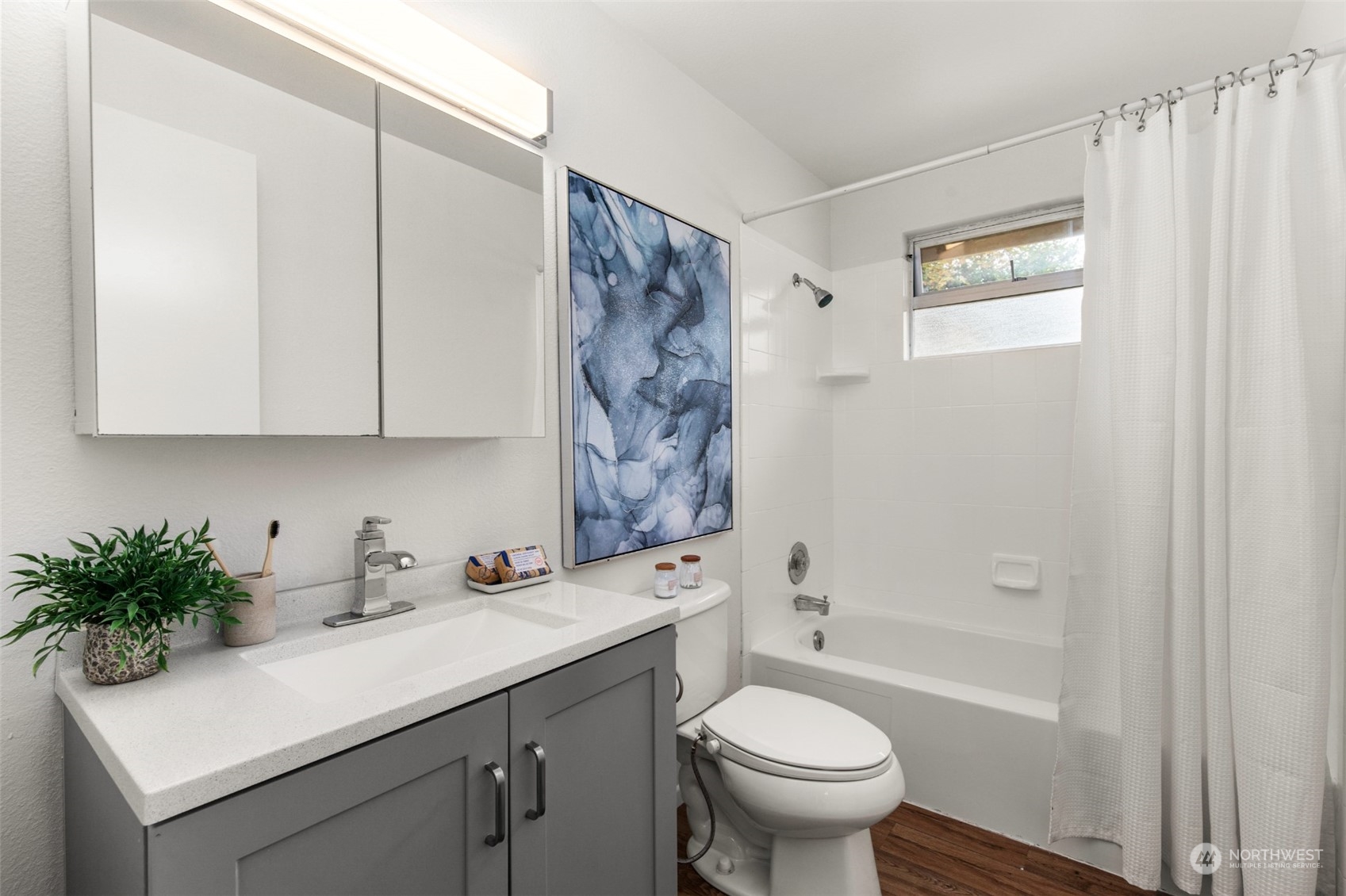 22700 1st Place West Bothell, WA 98021 - Photo 19 of 32 a bathroom with a sink toilet a mirror and shower