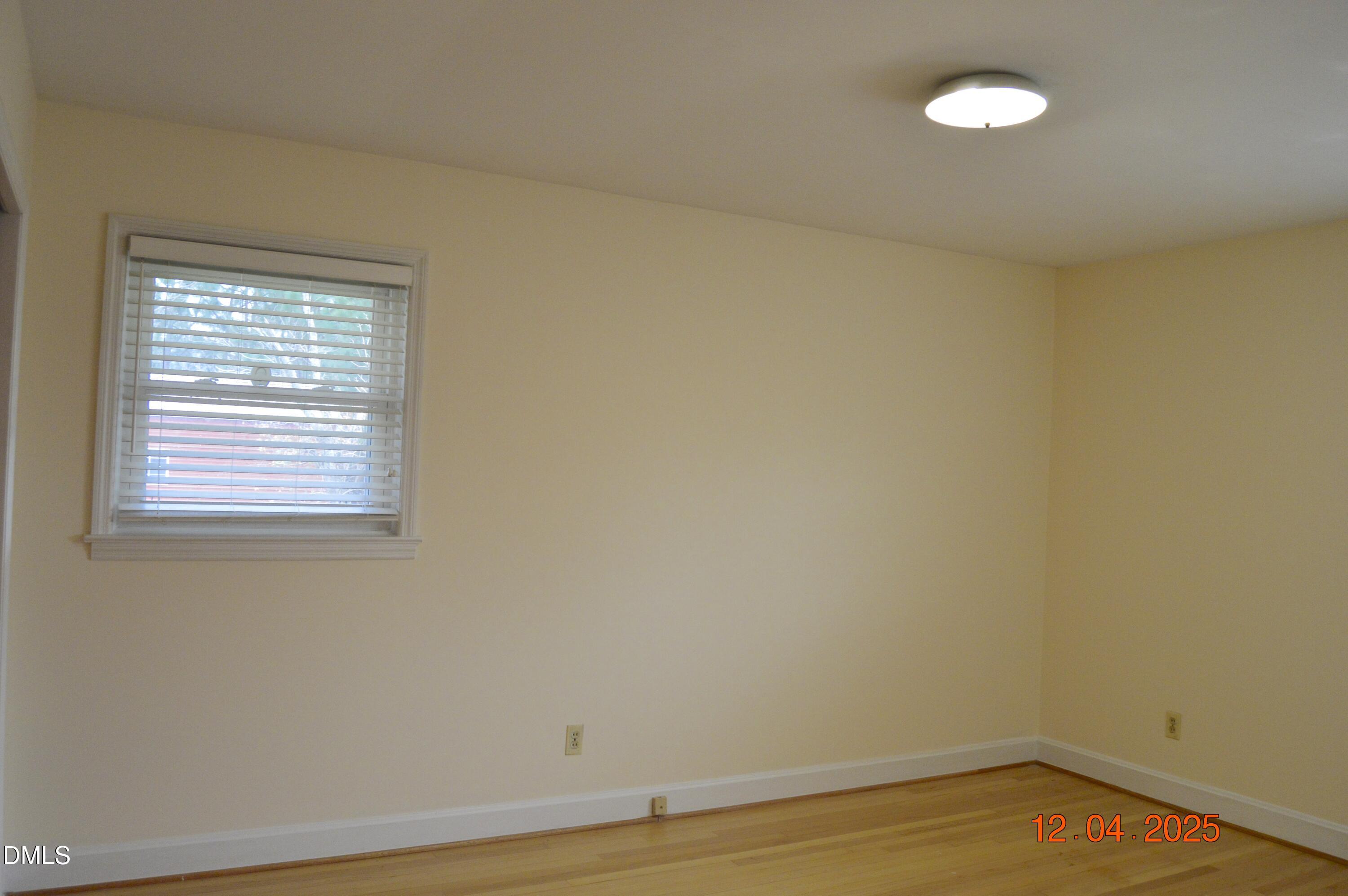 681 Polenta Road Smithfield, NC 27577 - Photo 21 of 34 a view of an empty room with wooden floor and a window