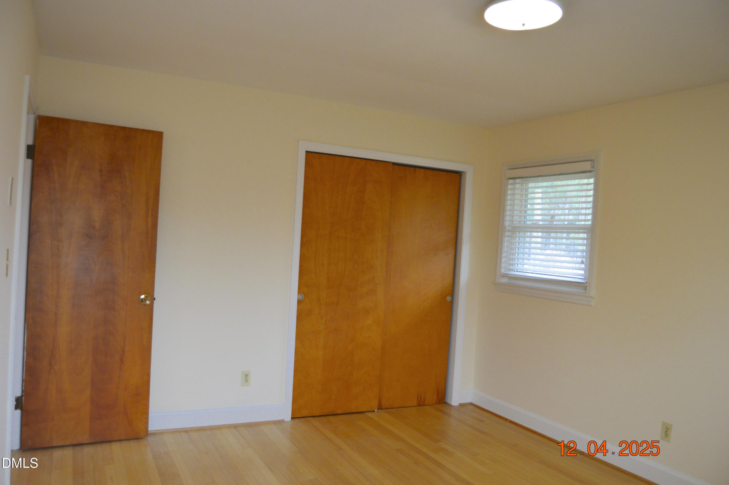 681 Polenta Road Smithfield, NC 27577 - Photo 22 of 34 a view of an empty room with wooden floor and a window