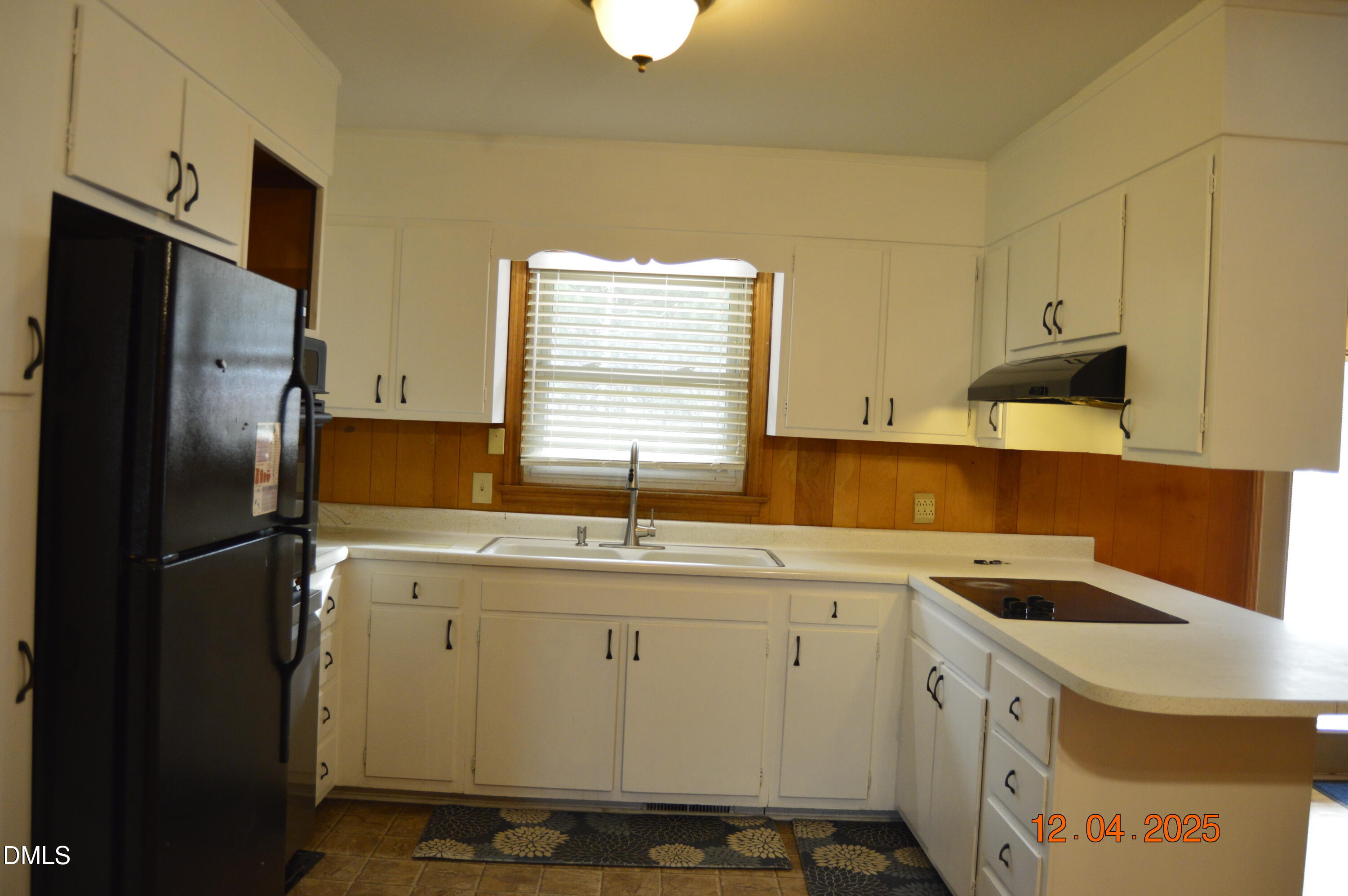 681 Polenta Road Smithfield, NC 27577 - Photo 8 of 34 a kitchen with a sink a refrigerator and cabinets