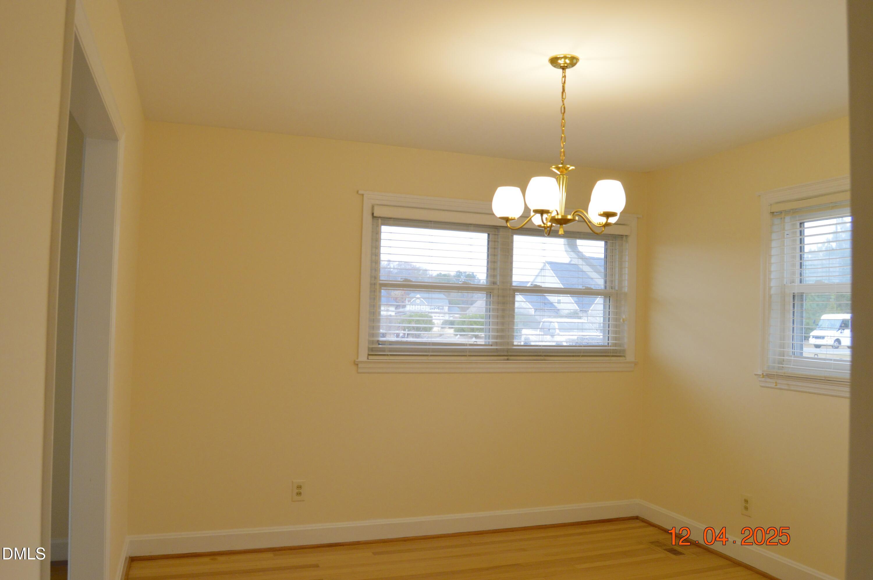 681 Polenta Road Smithfield, NC 27577 - Photo 9 of 34 a view of a room with wooden floor and windows