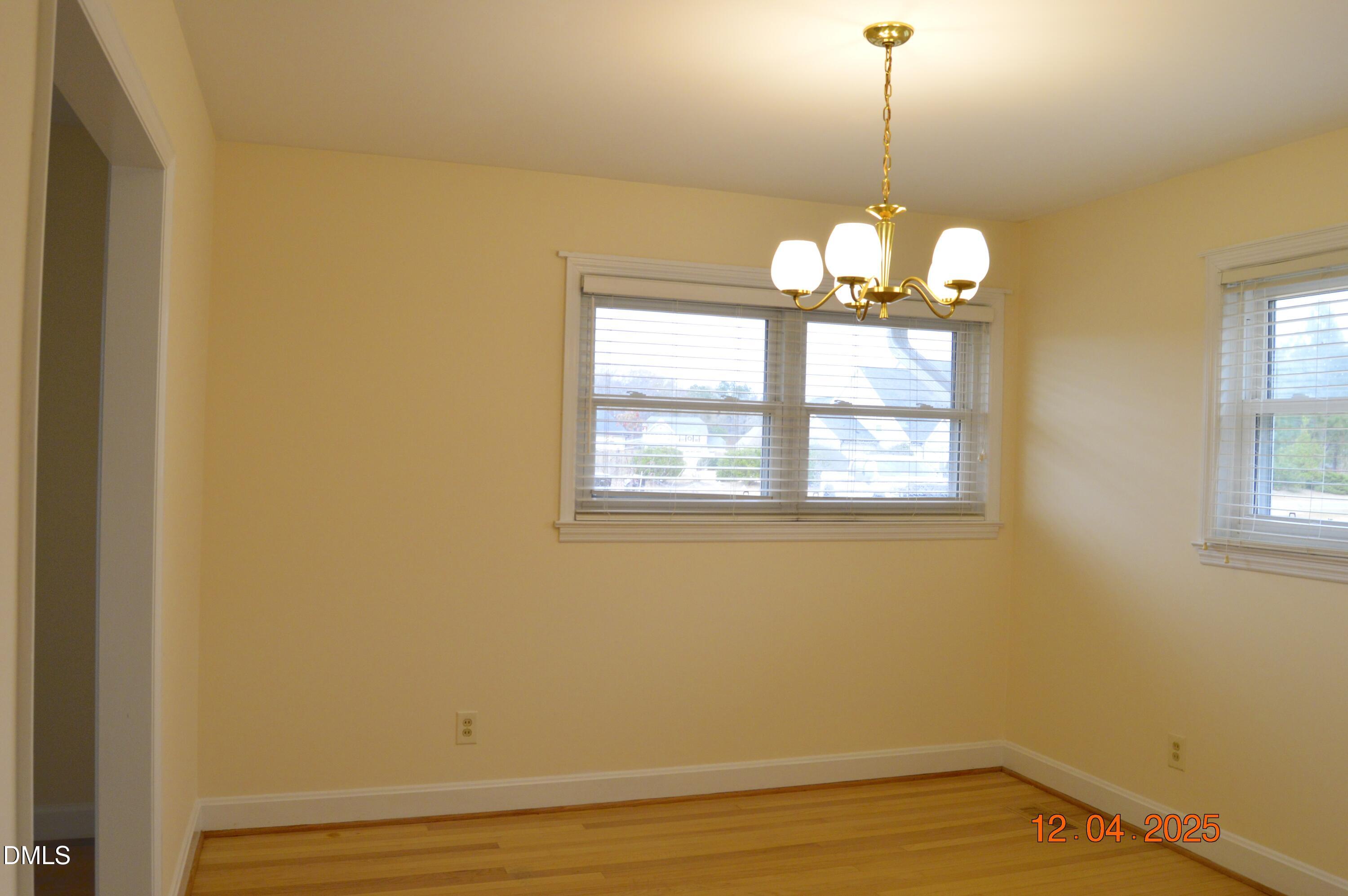 681 Polenta Road Smithfield, NC 27577 - Photo 10 of 34 a view of a room with wooden floor chandelier and a window