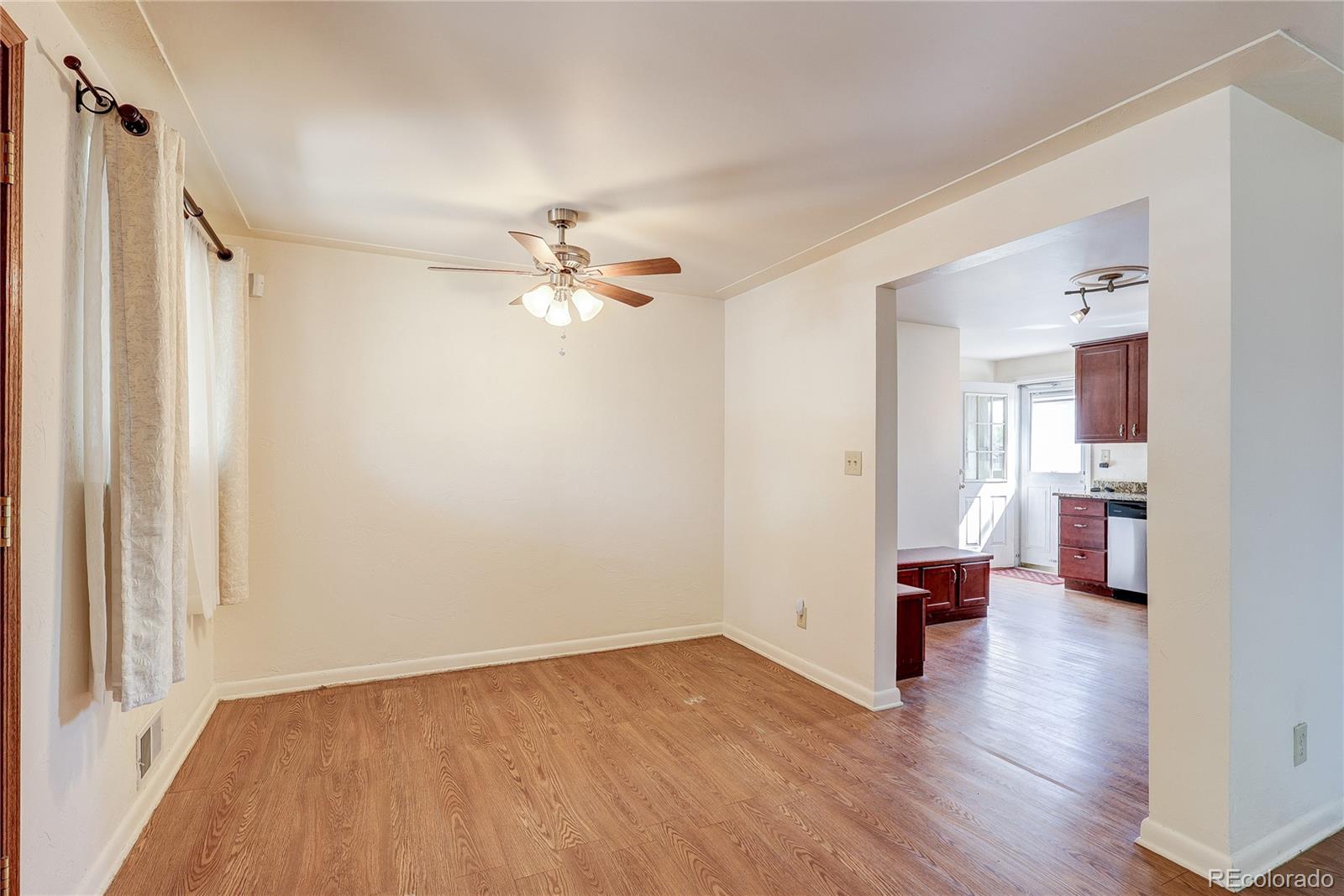 4570 Field Street Wheat Ridge, CO 80033 - Photo 12 of 44 a view of empty room with wooden floor and fan
