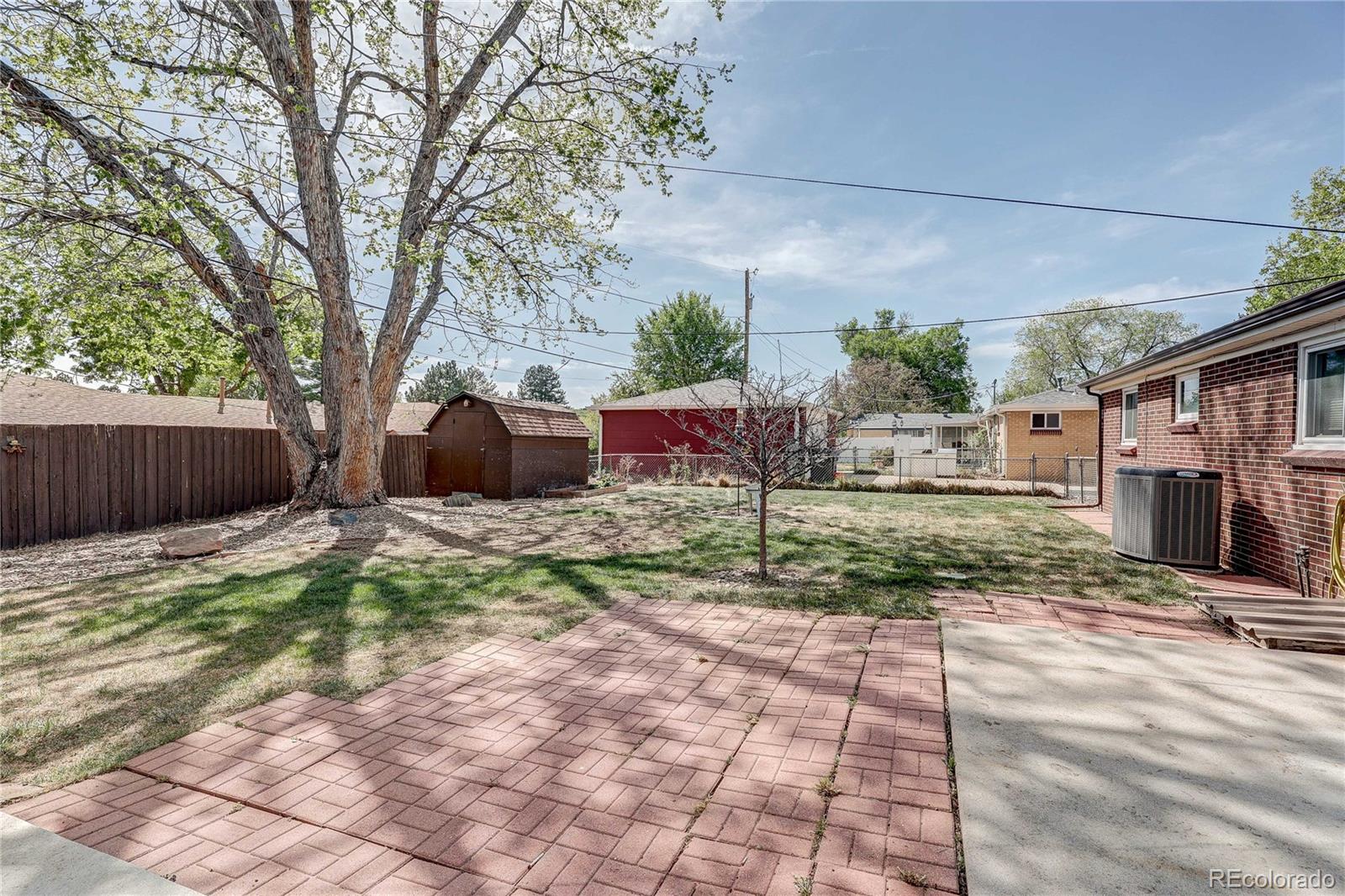 4570 Field Street Wheat Ridge, CO 80033 - Photo 29 of 44 a front view of a house with a yard