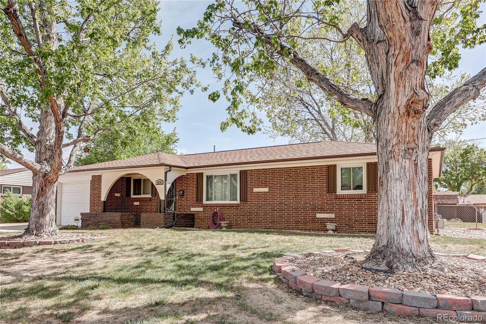 4570 Field Street Wheat Ridge, CO 80033 - Photo 3 of 44 a front view of a house with a yard and large tree