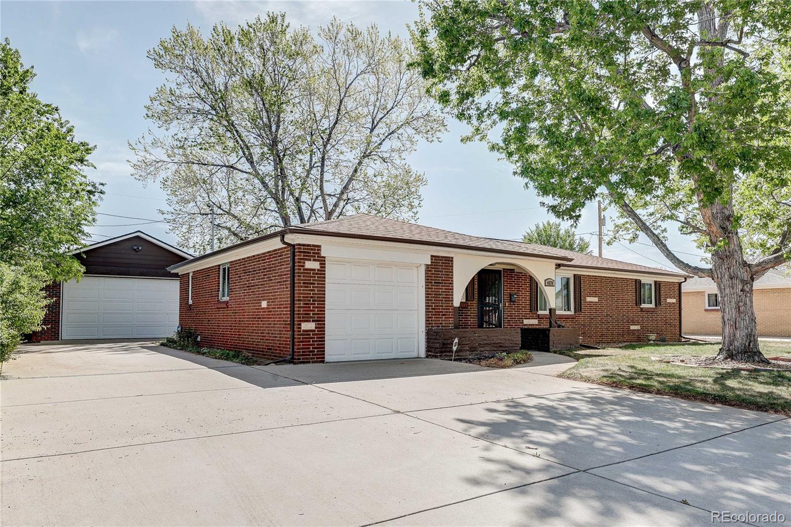 4570 Field Street Wheat Ridge, CO 80033 - Photo 4 of 44 a front view of a house with a yard and garage
