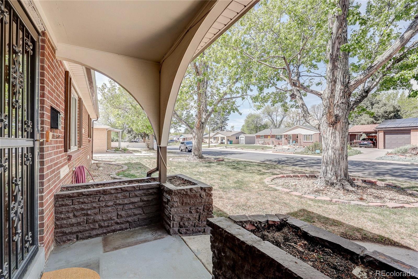 4570 Field Street Wheat Ridge, CO 80033 - Photo 5 of 44 a view of a trees and yard from a balcony