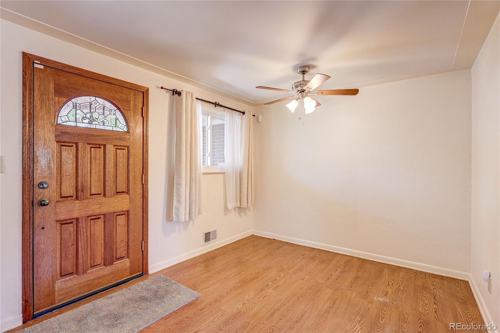 4570 Field Street Wheat Ridge, CO 80033 - Photo 6 of 44 an empty room with windows and fan