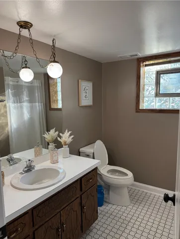 a bathroom with a sink a toilet and mirror