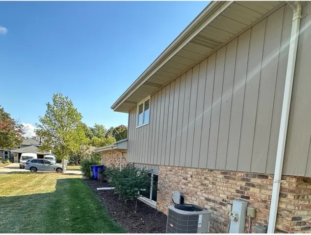 a backyard of a house with table and chairs