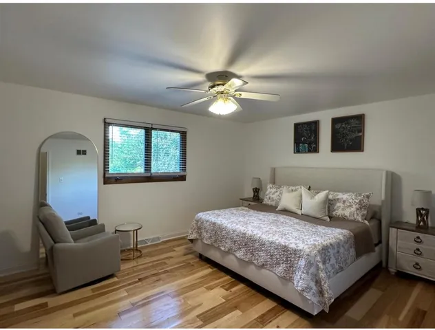 a bedroom with a bed and a couch