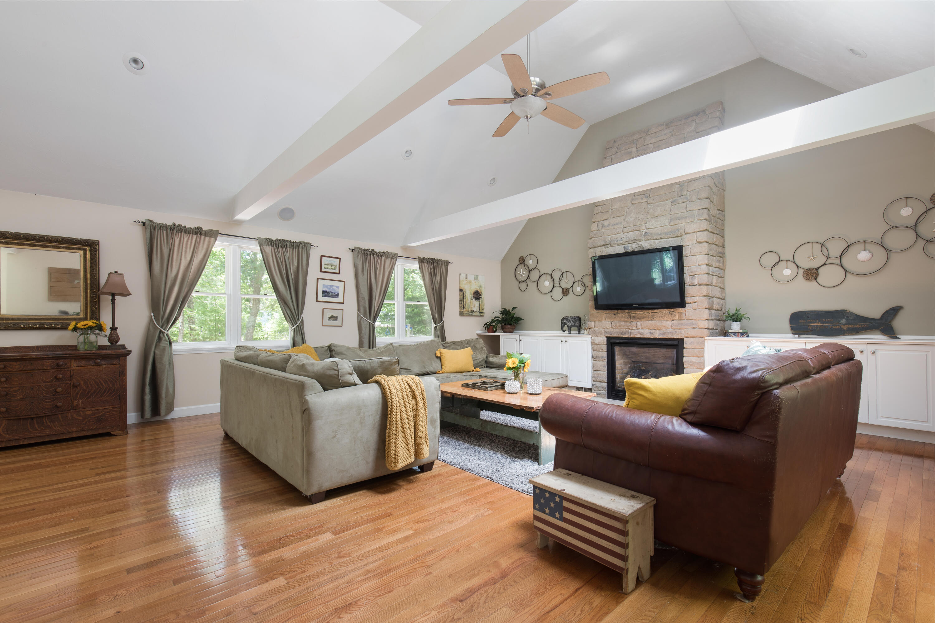 25 Weathervane Way Marstons Mills, MA 02632 - Photo 2 of 21 a living room with furniture a flat screen tv and a fireplace