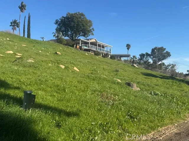 a yellow house with lots of trees