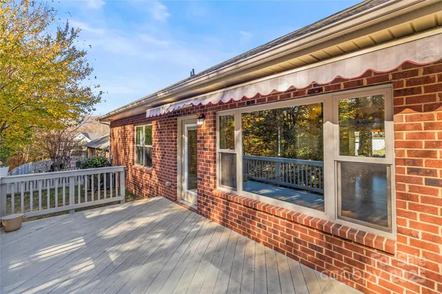 a view of balcony with wooden floor and fence