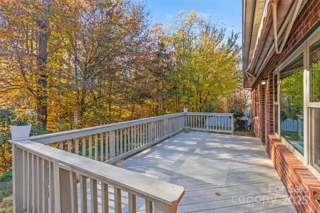 a view of balcony with wooden floor and fence