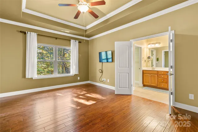 a spacious bathroom with a granite countertop sink a mirror and a shower