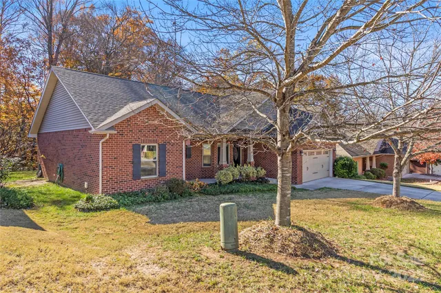 a view of a yard with wooden fence