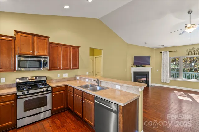 a view of a kitchen with a sink stove and refrigerator