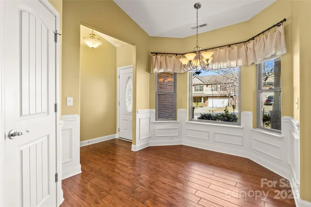 a view of a kitchen with wooden floor and a kitchen