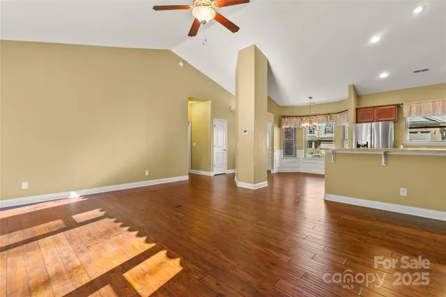 a view of a livingroom with furniture a fireplace and wooden floor