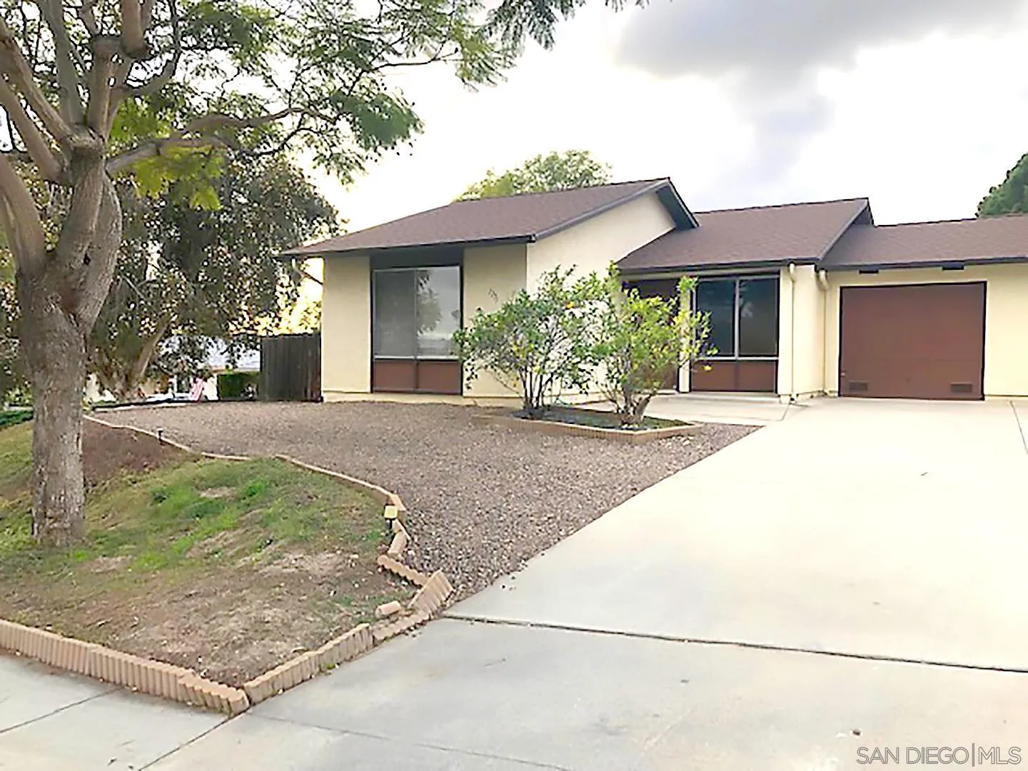 1771 Round Tree Drive Oceanside, CA 92056 - Photo 1 of 14 a front view of a house with a yard and garage