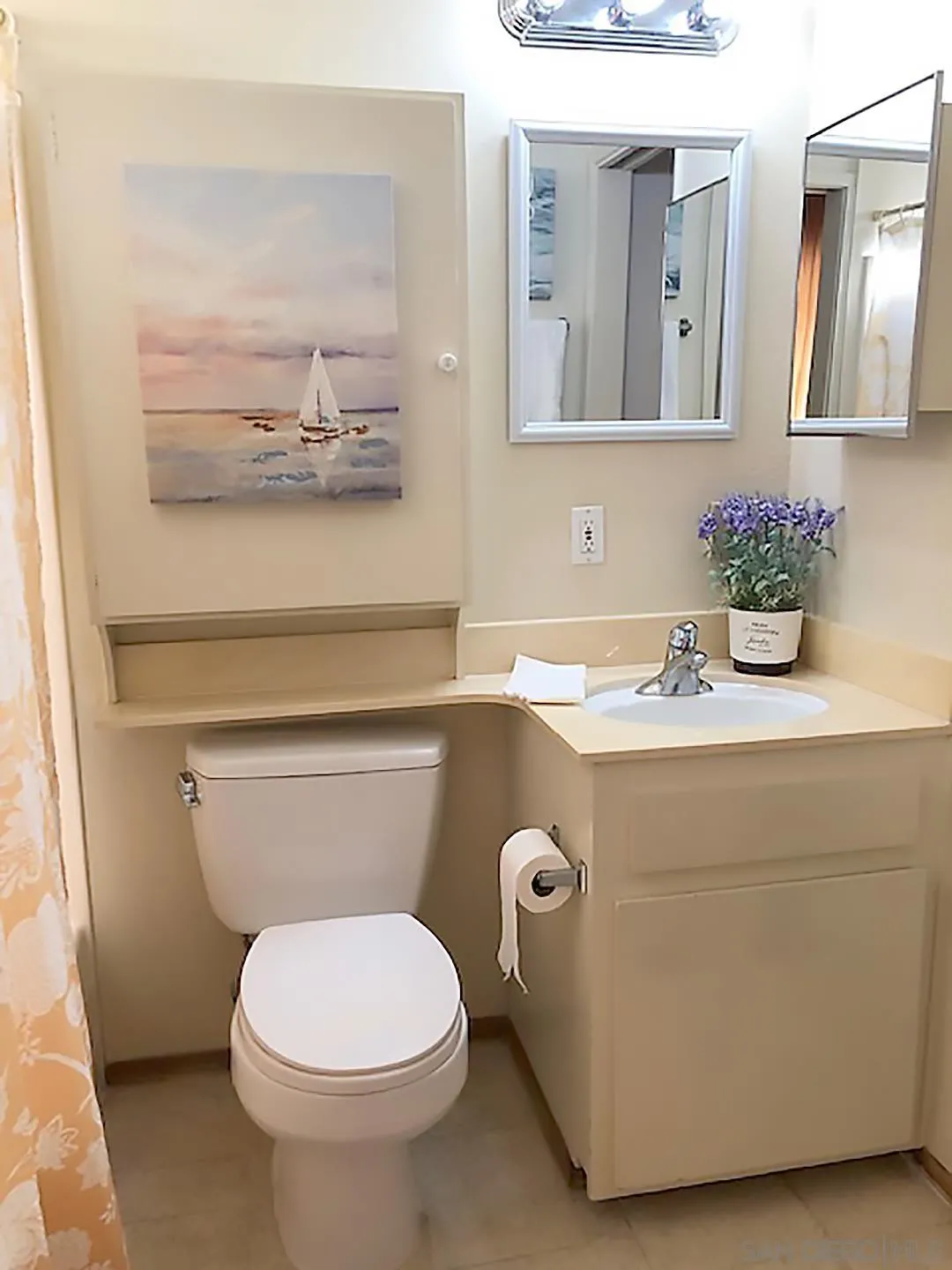 1771 Round Tree Drive Oceanside, CA 92056 - Photo 14 of 14 a bathroom with a toilet sink and mirror