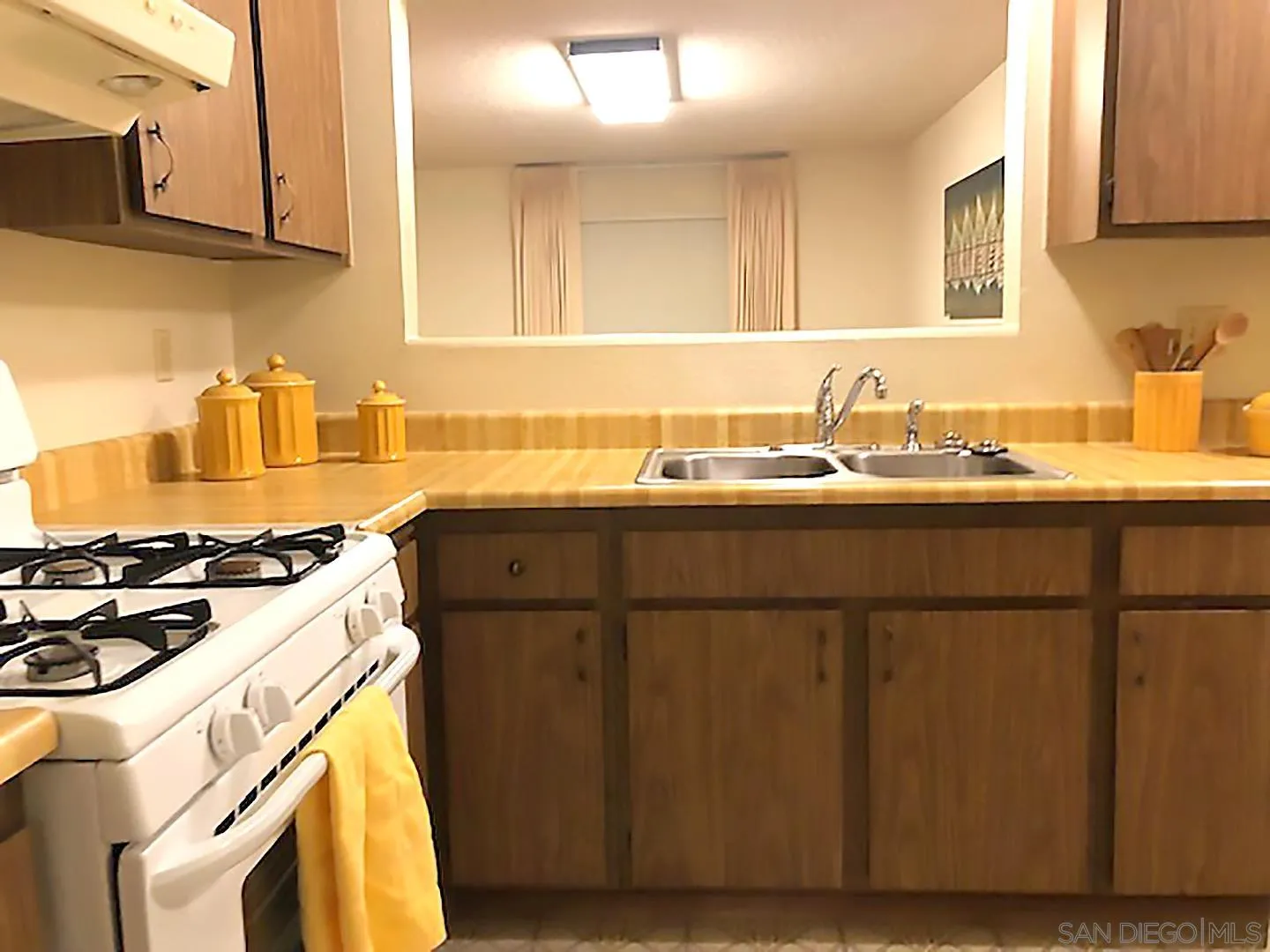 1771 Round Tree Drive Oceanside, CA 92056 - Photo 6 of 14 a kitchen with a sink a stove and cabinets