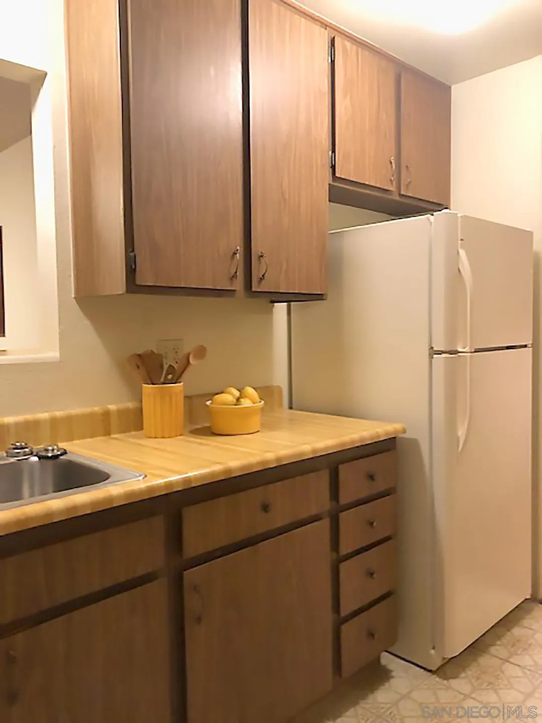 1771 Round Tree Drive Oceanside, CA 92056 - Photo 7 of 14 a kitchen with a sink and a refrigerator