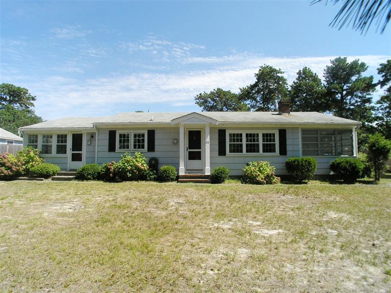 26 Edwards Road Dennis Port, MA 02639 - Photo 1 of 14 a front view of a house with a yard