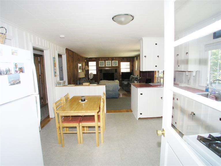 26 Edwards Road Dennis Port, MA 02639 - Photo 12 of 14 a view of a kitchen with dining table and chairs