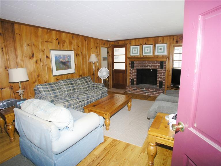26 Edwards Road Dennis Port, MA 02639 - Photo 3 of 14 a living room with furniture and a fireplace
