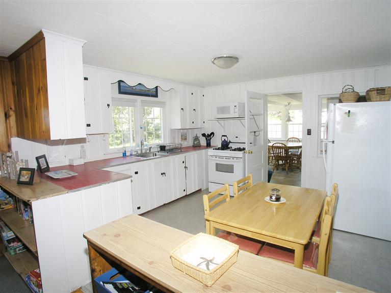 26 Edwards Road Dennis Port, MA 02639 - Photo 4 of 14 a kitchen with a stove a refrigerator and a sink