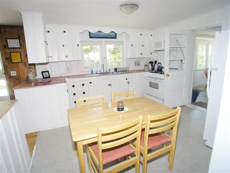 26 Edwards Road Dennis Port, MA 02639 - Photo 5 of 14 a kitchen with stainless steel appliances cabinets and wooden floor