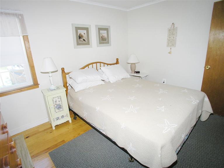 26 Edwards Road Dennis Port, MA 02639 - Photo 8 of 14 a bed sitting in a bedroom next to a window