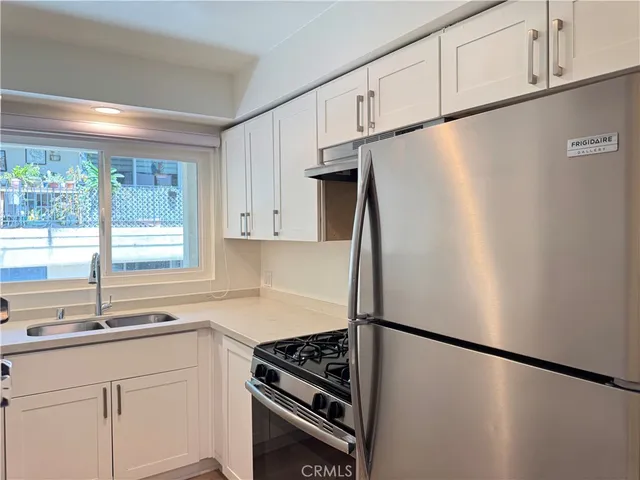 a kitchen with stainless steel appliances a refrigerator and a sink