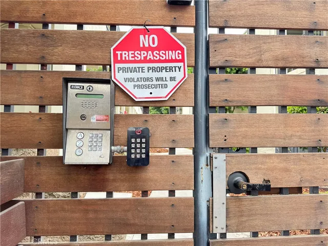 a view of a street with wooden fence