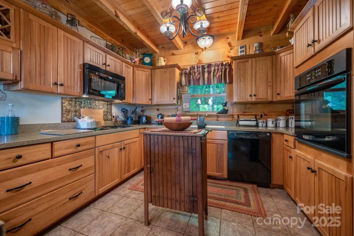 186 Black Ridge Drive Bostic, NC 28018 - Photo 13 of 47 a kitchen with granite countertop a stove top oven a sink dishwasher and cabinets with wooden floor